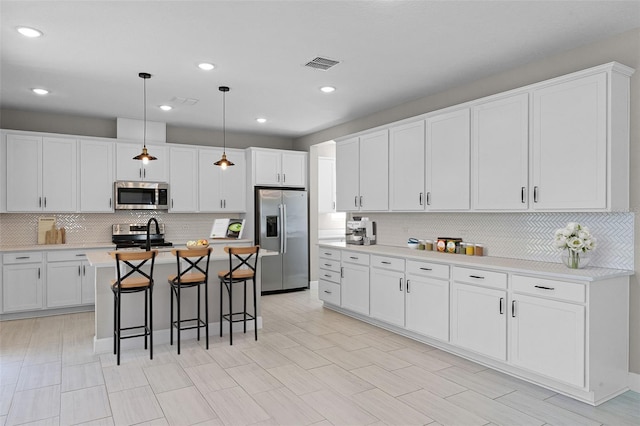 10249 Spring Lake Dr, Clermont, FL 34711 - kitchen with stainless steel appliances, tasteful backsplash, a kitchen breakfast bar, light countertops, and recessed lighting