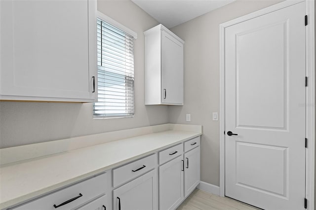 10249 Spring Lake Dr, Clermont, FL 34711 - kitchen featuring white cabinetry and light countertops