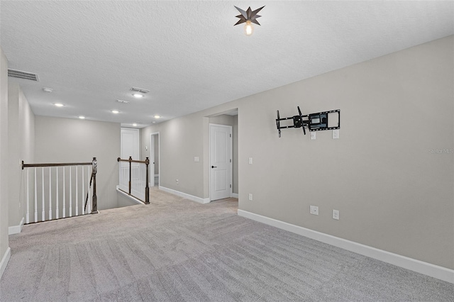 10249 Spring Lake Dr, Clermont, FL 34711 - spare room with light colored carpet, a textured ceiling, and recessed lighting