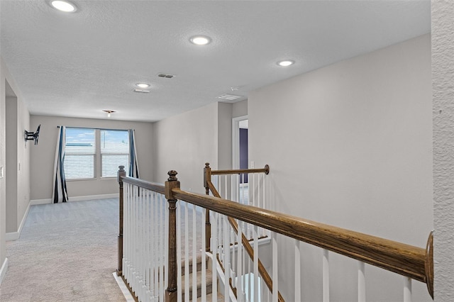 10249 Spring Lake Dr, Clermont, FL 34711 - hall with an upstairs landing, light carpet, a textured ceiling, and recessed lighting