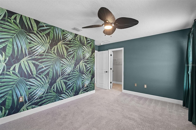 10249 Spring Lake Dr, Clermont, FL 34711 - spare room featuring carpet floors, a ceiling fan, and a textured ceiling