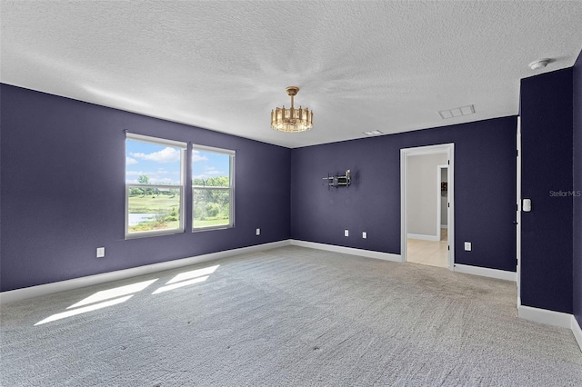 10249 Spring Lake Dr, Clermont, FL 34711 - spare room with a chandelier, light colored carpet, a smoke detector, and a textured ceiling