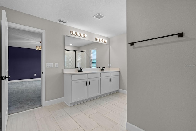 10249 Spring Lake Dr, Clermont, FL 34711 - bathroom with double vanity and a shower with shower door