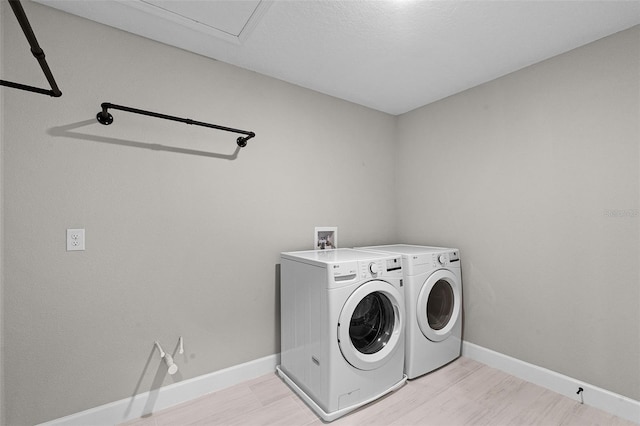10249 Spring Lake Dr, Clermont, FL 34711 - washroom with independent washer and dryer and light wood-style flooring