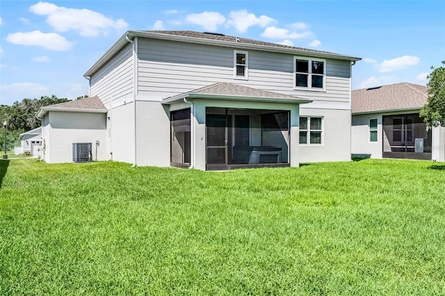10249 Spring Lake Dr, Clermont, FL 34711 - rear view of property featuring a sunroom, a lawn, a shingled roof, and stucco siding