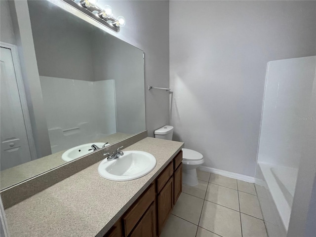514 Wilton Cir, Sanford, FL 32773 - full bathroom with tile patterned floors, vanity, toilet, a shower, and baseboards
