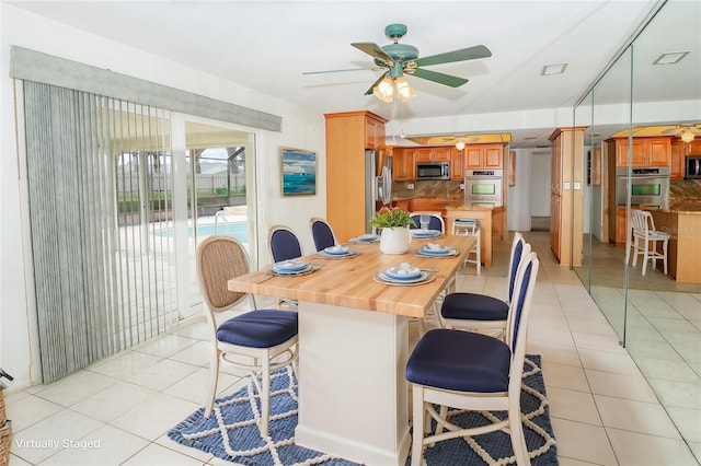 2 Pirates Cv, Ormond Beach, FL 32176 - dining area with light tile patterned flooring and ceiling fan