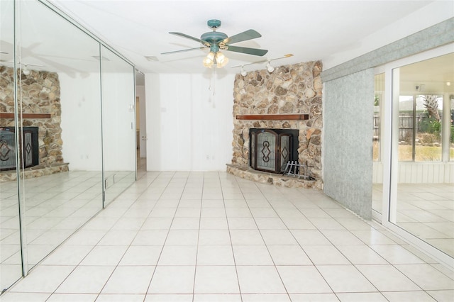 2 Pirates Cv, Ormond Beach, FL 32176 - unfurnished living room with a fireplace, a ceiling fan, track lighting, and tile patterned floors