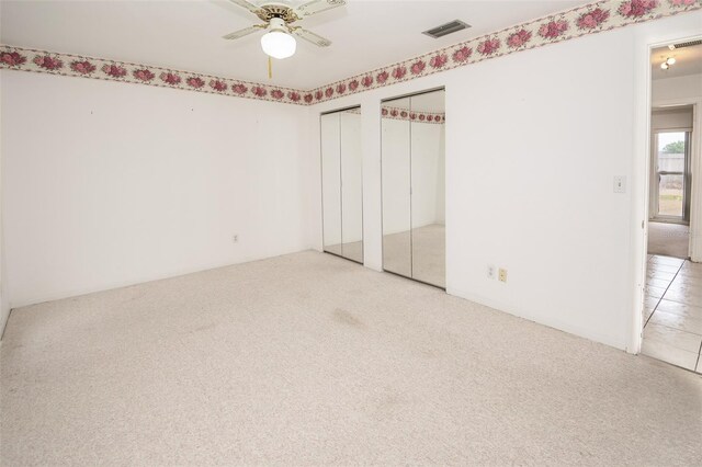 2 Pirates Cv, Ormond Beach, FL 32176 - unfurnished bedroom featuring multiple closets and carpet