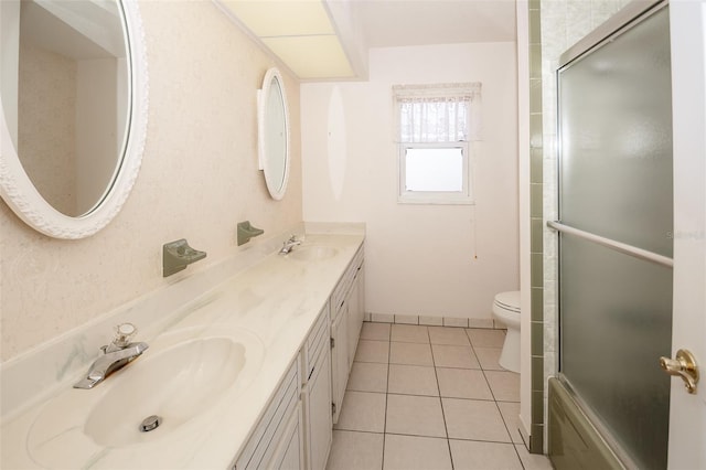 2 Pirates Cv, Ormond Beach, FL 32176 - full bathroom featuring an enclosed shower, toilet, double vanity, and tile patterned flooring