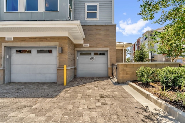 7573 Laureate Blvd Unit 1-404, Orlando, FL 32827 - garage featuring decorative driveway