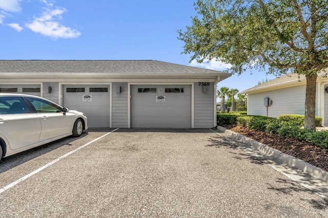 7573 Laureate Blvd Unit 1-404, Orlando, FL 32827 - garage featuring asphalt driveway