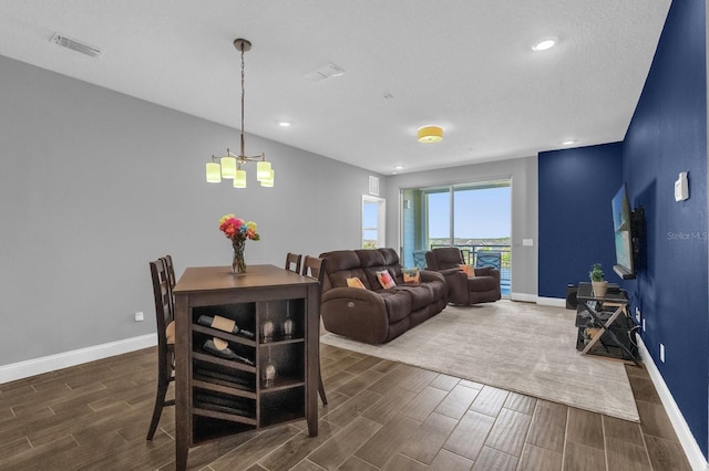 7573 Laureate Blvd Unit 1-404, Orlando, FL 32827 - dining space with wood tiled floors, baseboards, a chandelier, and recessed lighting