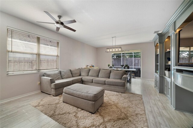 4558 Redmond Pl, Sanford, FL 32771 - living room with light wood-type flooring, a ceiling fan, and baseboards