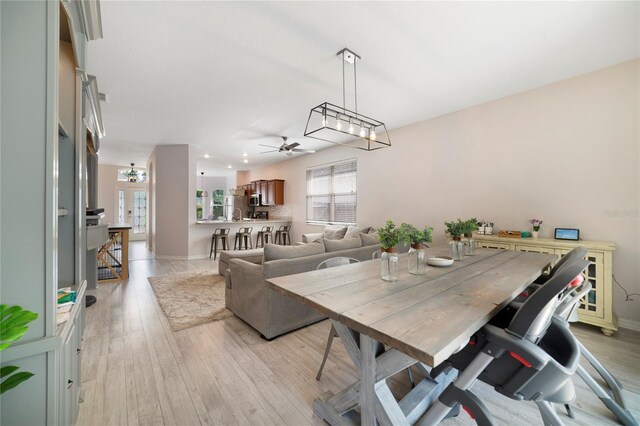 4558 Redmond Pl, Sanford, FL 32771 - dining space with ceiling fan, light wood finished floors, and baseboards
