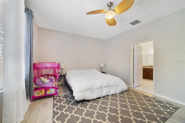 4558 Redmond Pl, Sanford, FL 32771 - bedroom featuring wood finished floors, connected bathroom, and baseboards