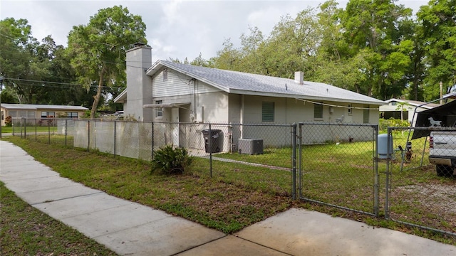 715 Ballard St, Altamonte Springs, FL 32701 - view of home's exterior with a gate, a chimney, and central air condition unit