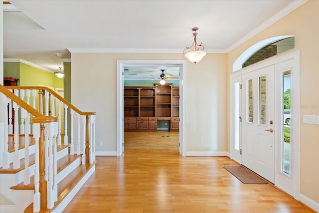 17631 Vista Belle Ct, Montverde, FL 34756 - foyer entrance with light wood-type flooring, ornamental molding, stairs, baseboards, and a ceiling fan