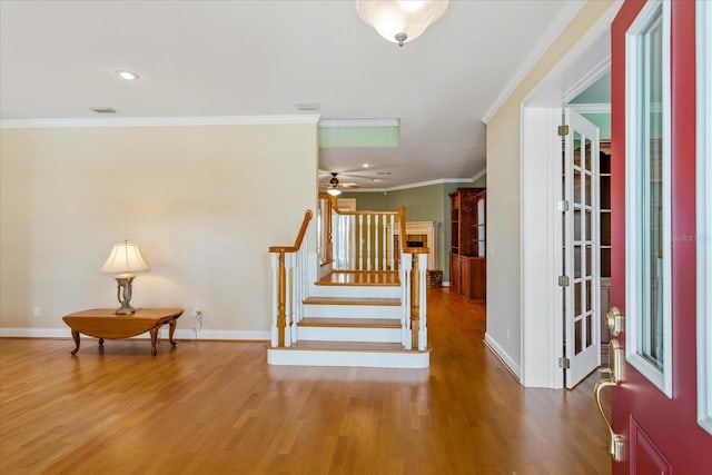 17631 Vista Belle Ct, Montverde, FL 34756 - entrance foyer with wood finished floors, baseboards, stairs, ornamental molding, and ceiling fan