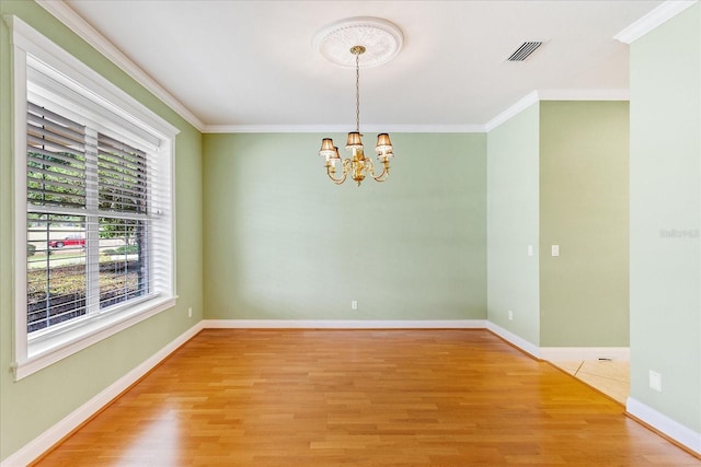 17631 Vista Belle Ct, Montverde, FL 34756 - empty room featuring a chandelier, light wood-style flooring, ornamental molding, and baseboards