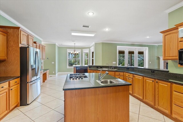 17631 Vista Belle Ct, Montverde, FL 34756 - kitchen with black appliances, a sink, light tile patterned floors, a chandelier, and crown molding
