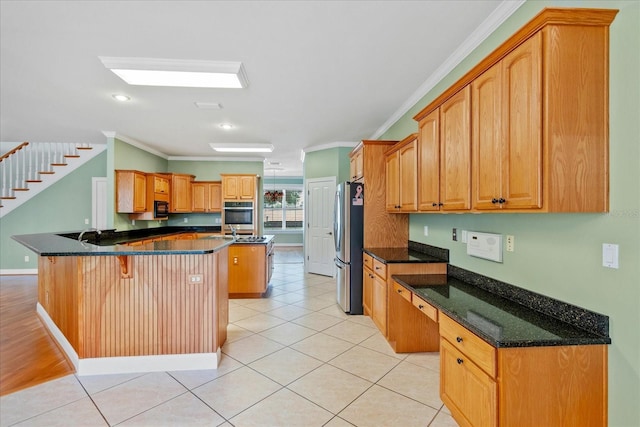17631 Vista Belle Ct, Montverde, FL 34756 - kitchen with appliances with stainless steel finishes, ornamental molding, a peninsula, a kitchen breakfast bar, and light tile patterned floors