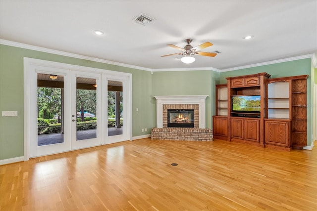 17631 Vista Belle Ct, Montverde, FL 34756 - unfurnished living room featuring baseboards, light wood-style flooring, crown molding, ceiling fan, and a fireplace