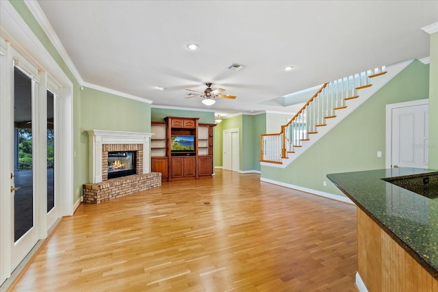 17631 Vista Belle Ct, Montverde, FL 34756 - unfurnished living room with ornamental molding, stairs, light wood-style floors, baseboards, and ceiling fan