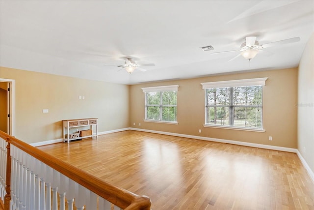 17631 Vista Belle Ct, Montverde, FL 34756 - empty room featuring a ceiling fan, light wood-style flooring, and baseboards