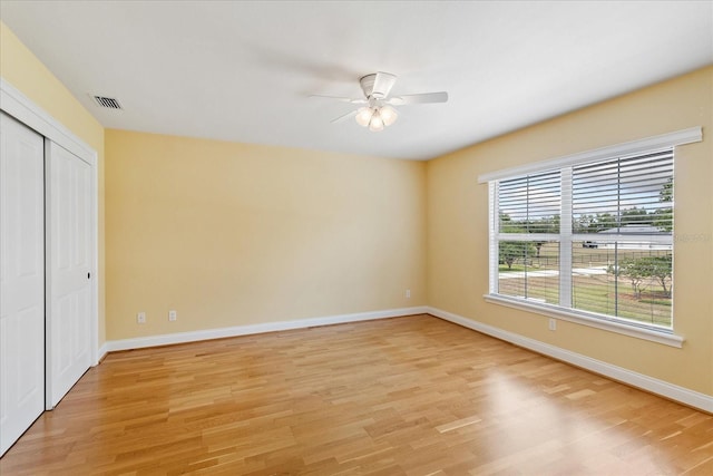 17631 Vista Belle Ct, Montverde, FL 34756 - unfurnished bedroom with light wood-style floors, baseboards, a closet, and a ceiling fan