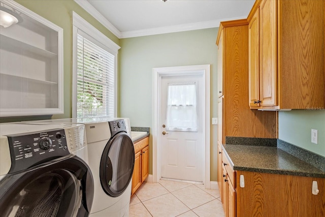 17631 Vista Belle Ct, Montverde, FL 34756 - washroom featuring cabinet space, washing machine and clothes dryer, light tile patterned flooring, and crown molding