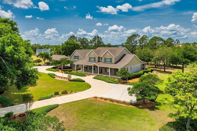 17631 Vista Belle Ct, Montverde, FL 34756 - view of front of house with curved driveway, covered porch, and a front yard