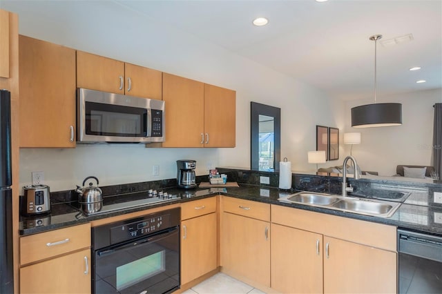 kitchen with black appliances, a sink, light tile patterned floors, hanging light fixtures, and dark stone counters