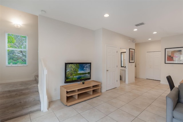 living room with stairs, light tile patterned floors, recessed lighting, and baseboards