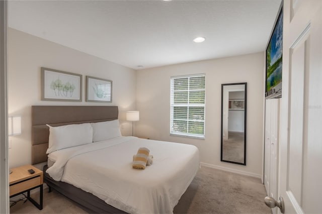 bedroom featuring light colored carpet, baseboards, and recessed lighting