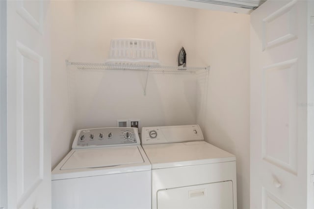 clothes washing area featuring separate washer and dryer