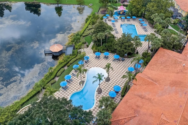 drone / aerial view of a pool area and a nearby body of water