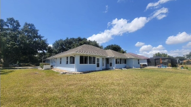 back of house featuring a lawn