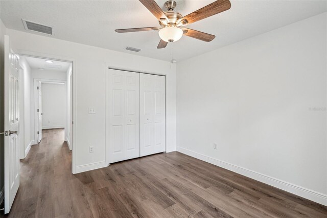 13881 SW 80th Ave, Ocala, FL 34473 - unfurnished bedroom featuring wood finished floors, baseboards, a closet, and a ceiling fan