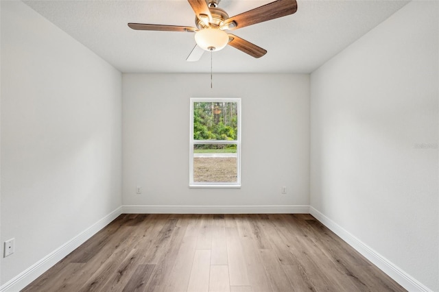 13881 SW 80th Ave, Ocala, FL 34473 - spare room with wood finished floors, baseboards, and ceiling fan