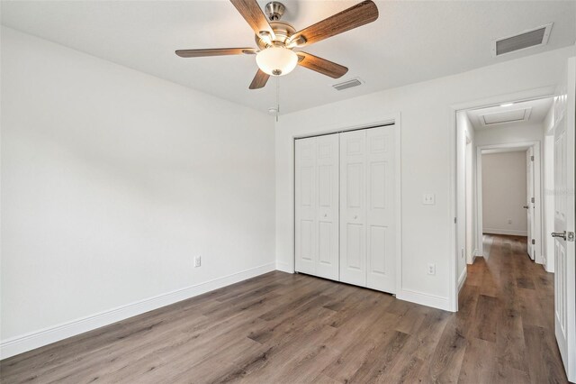13881 SW 80th Ave, Ocala, FL 34473 - unfurnished bedroom featuring attic access, wood finished floors, a closet, baseboards, and ceiling fan