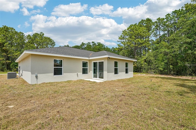 13881 SW 80th Ave, Ocala, FL 34473 - rear view of property with a lawn, stucco siding, and central air condition unit
