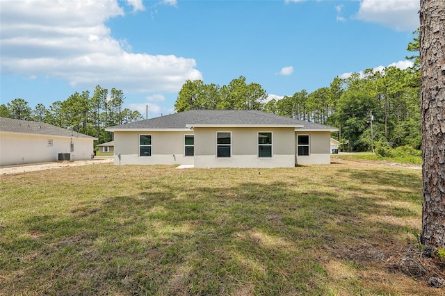 13881 SW 80th Ave, Ocala, FL 34473 - back of property with stucco siding, a yard, and roof with shingles