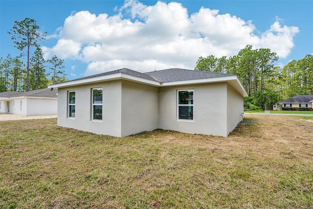 13881 SW 80th Ave, Ocala, FL 34473 - view of home's exterior featuring stucco siding and a yard