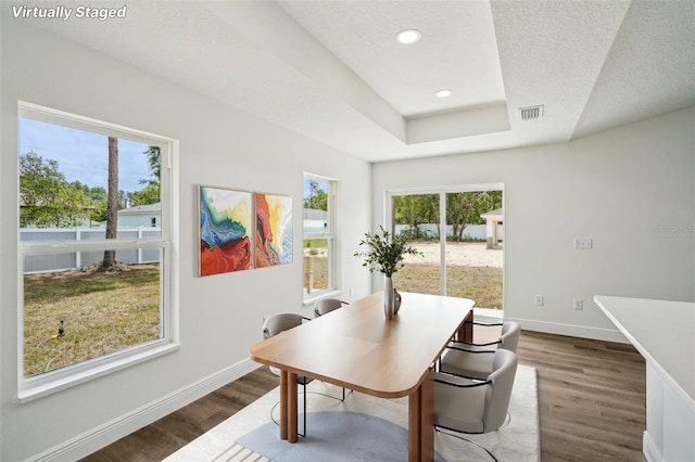 13881 SW 80th Ave, Ocala, FL 34473 - dining space featuring dark wood-type flooring, baseboards, a desk, a tray ceiling, and recessed lighting