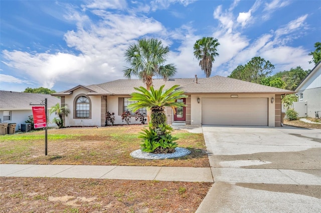 ranch-style house with a garage, stucco siding, concrete driveway, and central air condition unit