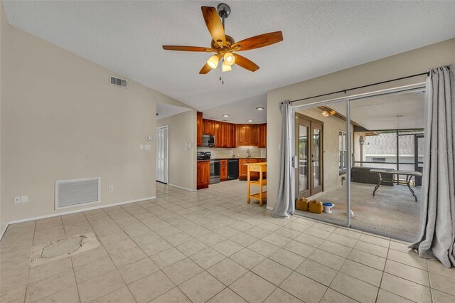 unfurnished living room featuring a ceiling fan, light tile patterned floors, baseboards, a textured ceiling, and recessed lighting
