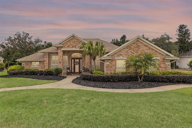 441 Hightower Dr, Debary, FL 32713 - view of front facade featuring brick siding, a front yard, and roof with shingles