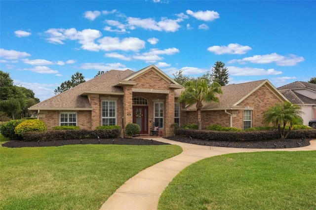 441 Hightower Dr, Debary, FL 32713 - view of front facade featuring brick siding, a front yard, and a shingled roof