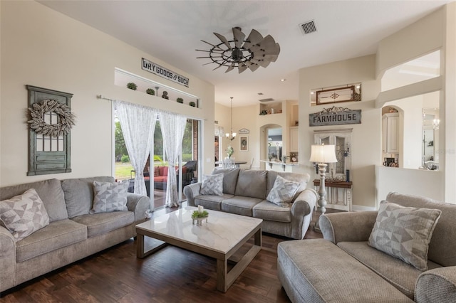 441 Hightower Dr, Debary, FL 32713 - living area featuring dark wood finished floors, arched walkways, and a chandelier